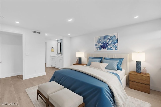 bedroom featuring visible vents, baseboards, light wood-type flooring, recessed lighting, and ensuite bathroom