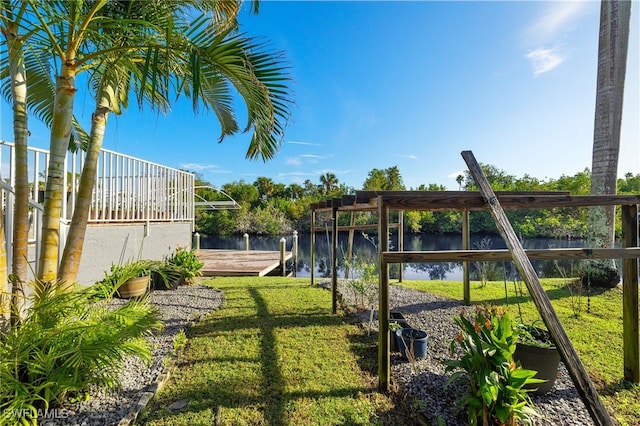 view of yard featuring a water view and a dock