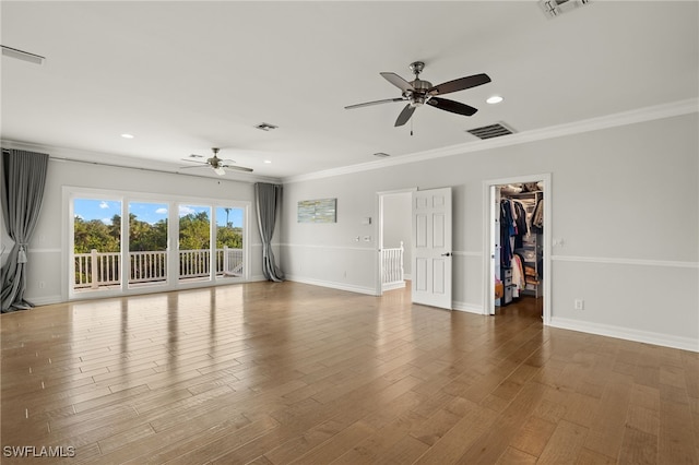 empty room with ceiling fan, wood-type flooring, and crown molding