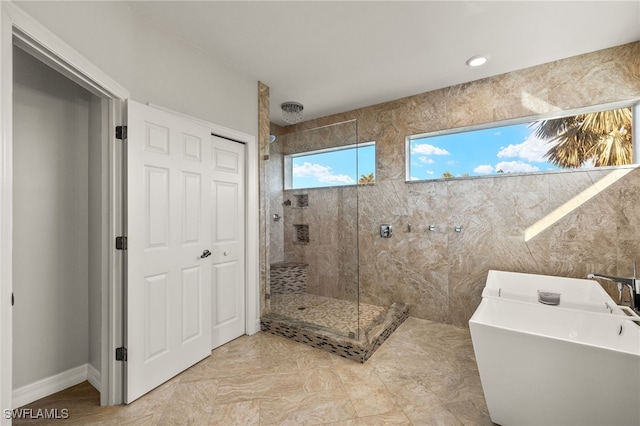 bathroom featuring tile patterned floors and shower with separate bathtub