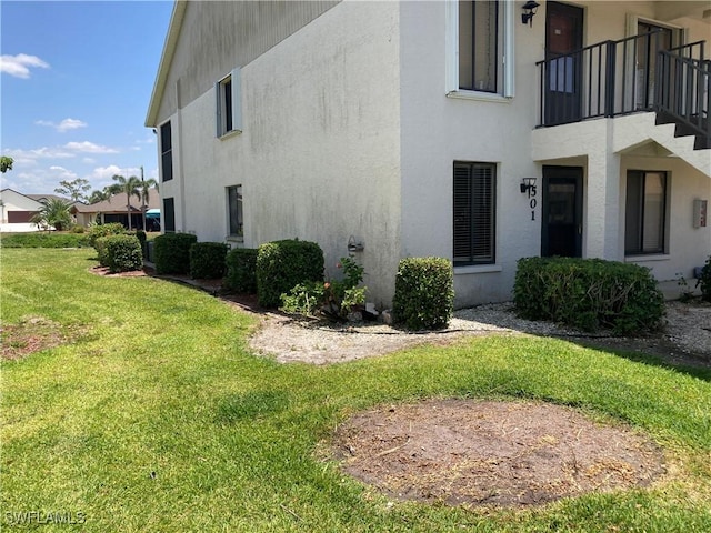 view of property exterior featuring a lawn