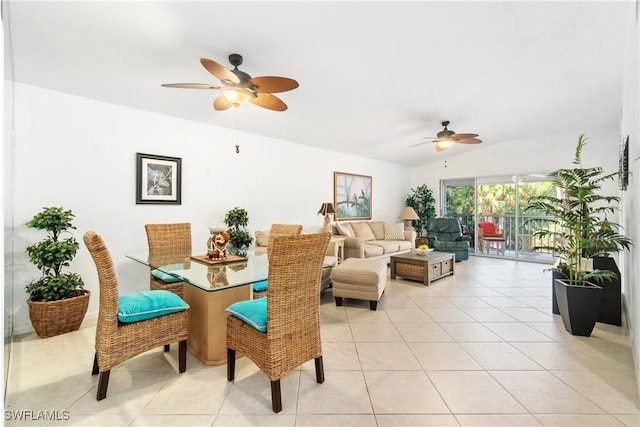 dining space with light tile patterned floors and vaulted ceiling