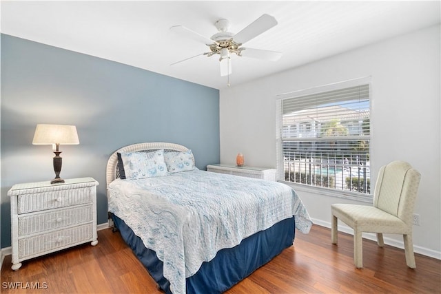 bedroom with ceiling fan and dark hardwood / wood-style flooring