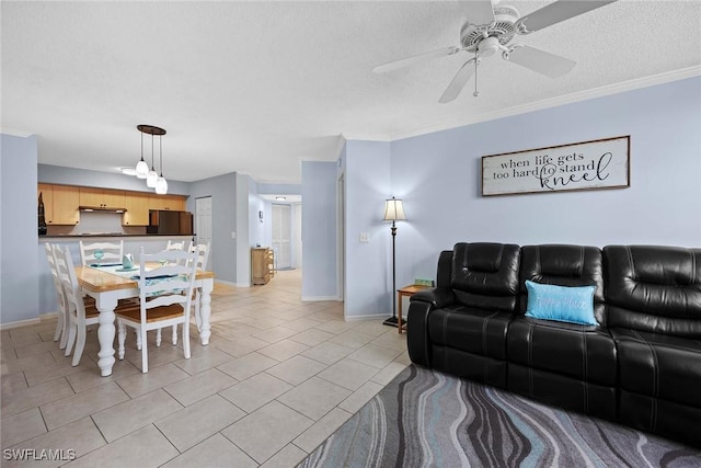 living room featuring ceiling fan, light tile patterned flooring, a textured ceiling, and ornamental molding