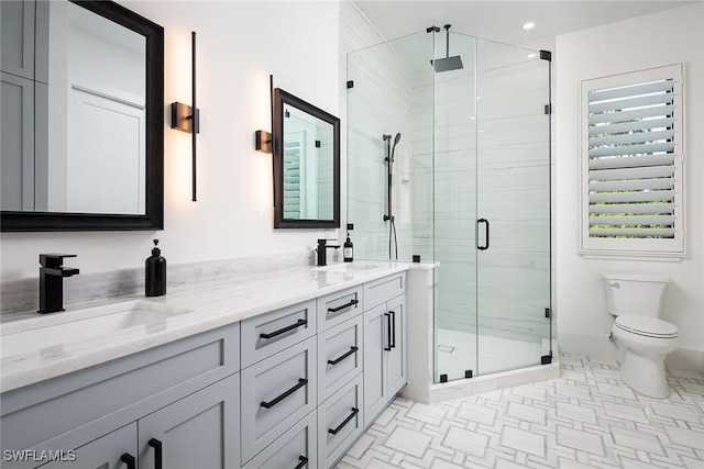 bathroom with tile patterned flooring, vanity, toilet, and a shower with shower door