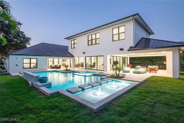 rear view of house with a pool with hot tub, a patio area, an outdoor hangout area, and a yard