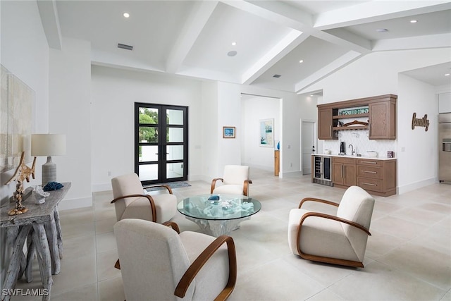 living room featuring french doors, lofted ceiling with beams, wine cooler, and wet bar