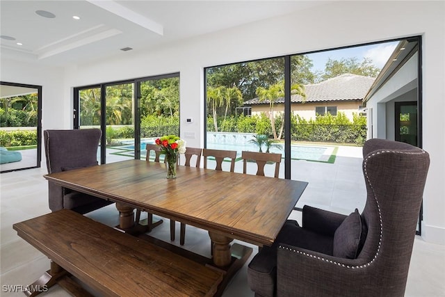 dining area featuring a raised ceiling