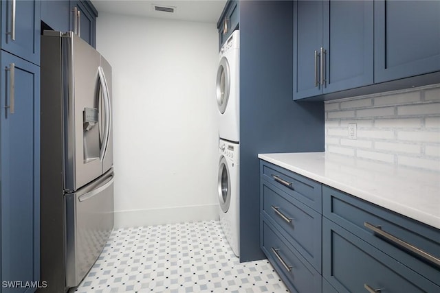 laundry room featuring stacked washer and dryer