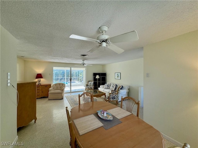 dining room with ceiling fan and a textured ceiling