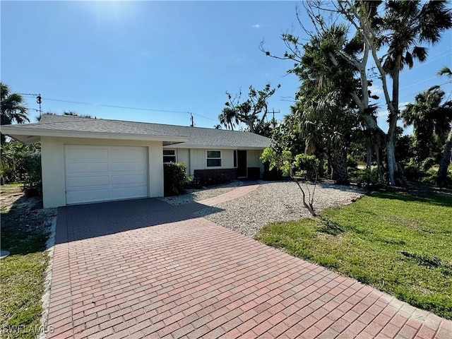 ranch-style home with a front yard and a garage