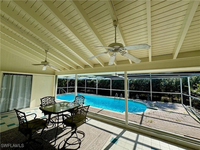 view of pool with ceiling fan, a patio, and glass enclosure