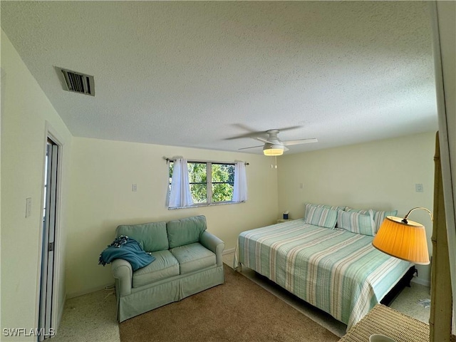 bedroom featuring ceiling fan and a textured ceiling