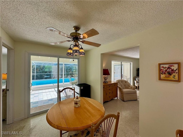 dining room with ceiling fan and a textured ceiling