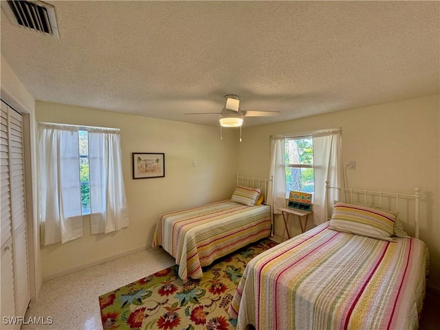 bedroom featuring a textured ceiling and ceiling fan