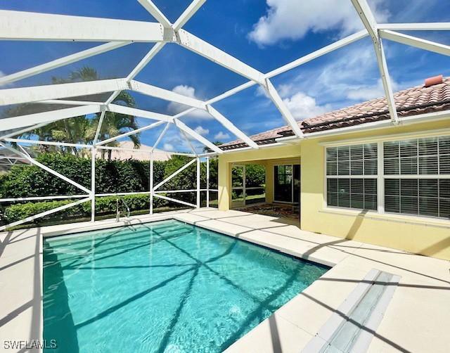 view of pool with a patio and a lanai