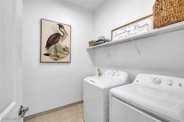 laundry area with separate washer and dryer and light tile patterned floors