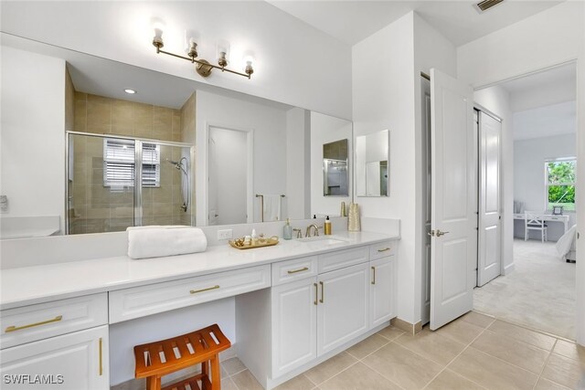 bathroom featuring tile patterned floors, vanity, and an enclosed shower