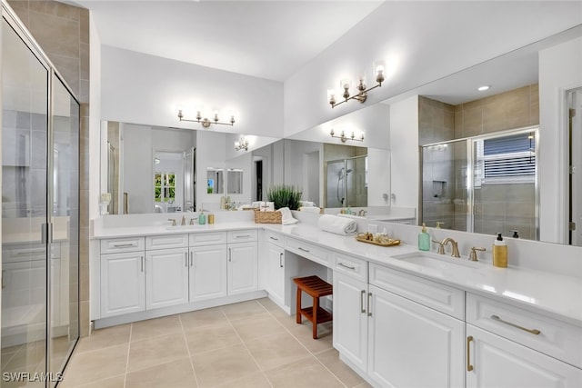 bathroom with an enclosed shower, vanity, and tile patterned floors