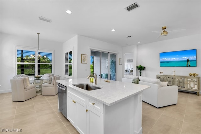 kitchen featuring sink, white cabinetry, hanging light fixtures, a center island with sink, and dishwasher