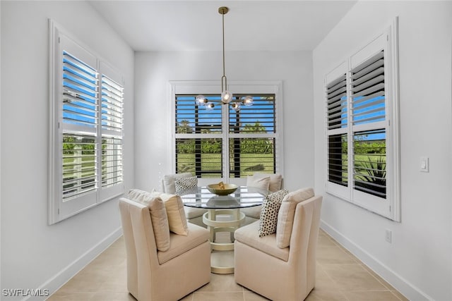 dining space with an inviting chandelier and light tile patterned floors