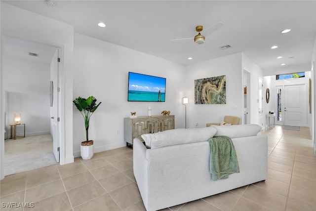 living room featuring light tile patterned flooring and ceiling fan