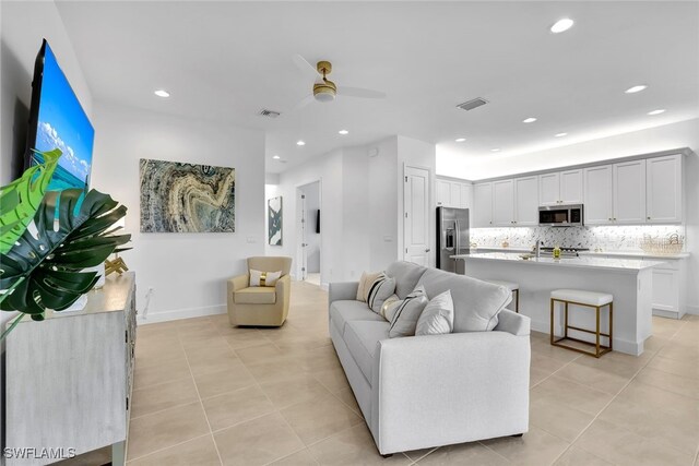 living room with light tile patterned floors and ceiling fan