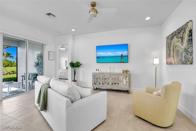 living room featuring light tile patterned floors and ceiling fan