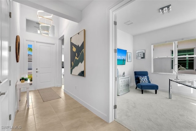 entryway with light carpet and plenty of natural light