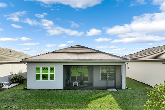 rear view of property featuring a yard