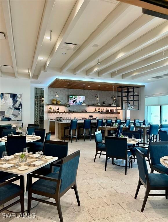 dining room featuring beamed ceiling