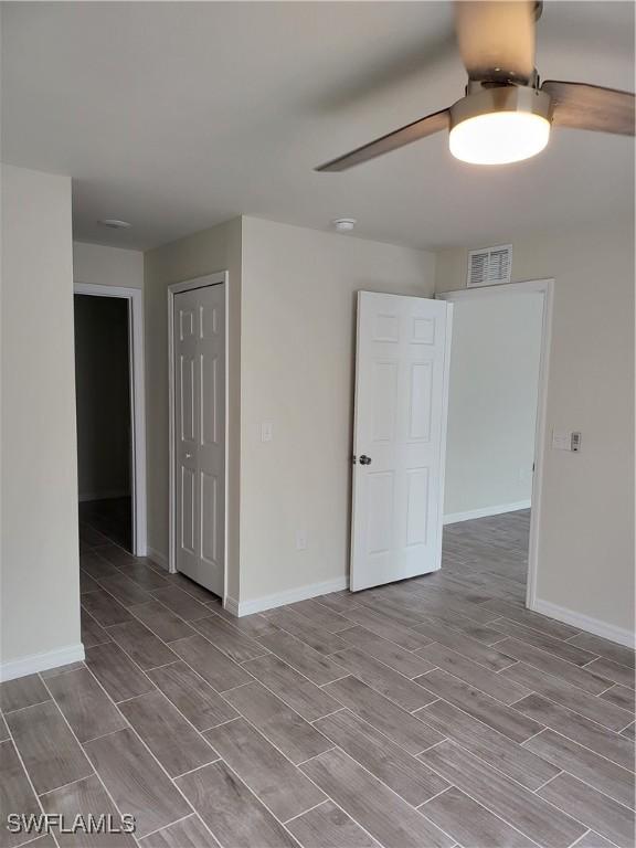 unfurnished room featuring light hardwood / wood-style flooring and ceiling fan