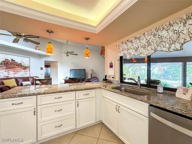 kitchen featuring stainless steel dishwasher, crown molding, sink, decorative light fixtures, and white cabinetry