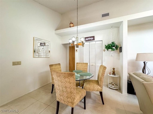 dining space featuring a notable chandelier, light tile patterned floors, and high vaulted ceiling