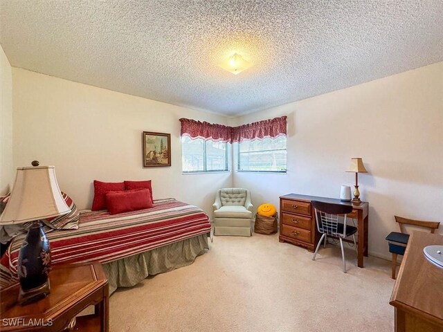 bedroom with carpet and a textured ceiling