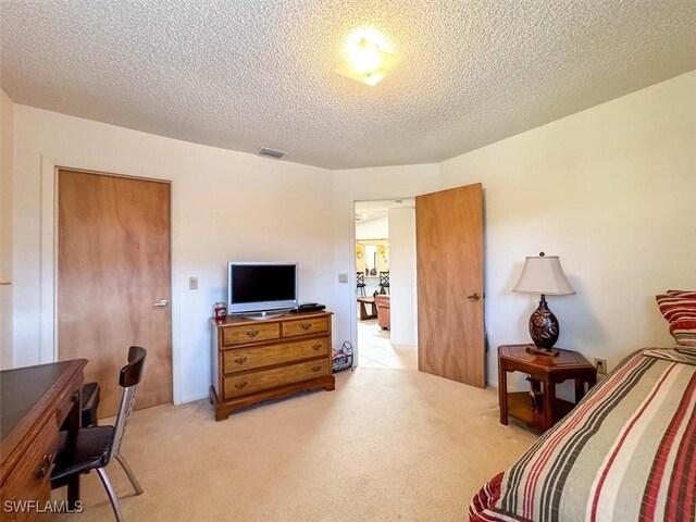 interior space with light colored carpet and a textured ceiling