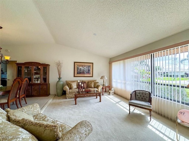 carpeted living room featuring a textured ceiling and vaulted ceiling