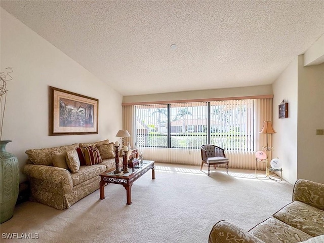 carpeted living room with a textured ceiling and vaulted ceiling