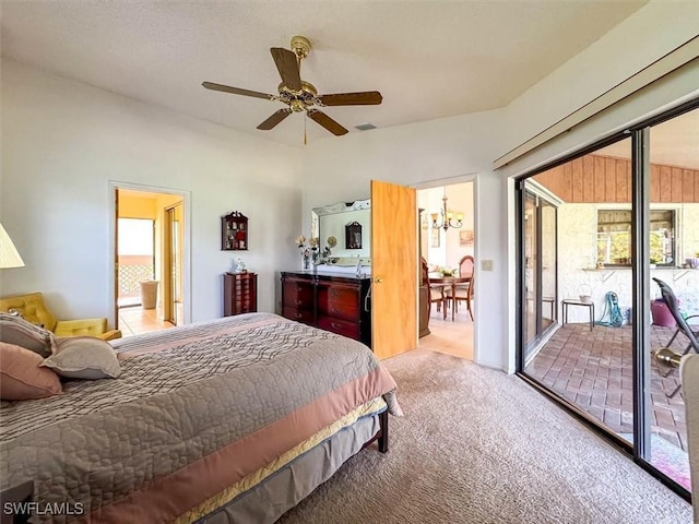 carpeted bedroom featuring access to exterior and ceiling fan with notable chandelier