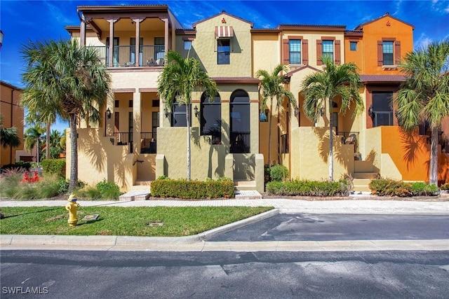 mediterranean / spanish-style home featuring a balcony