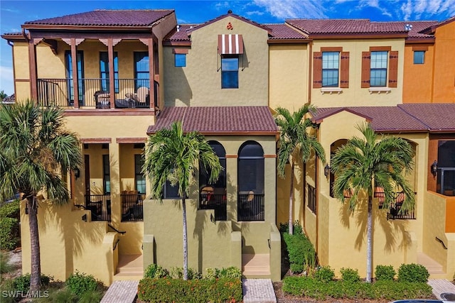 mediterranean / spanish-style home featuring a balcony