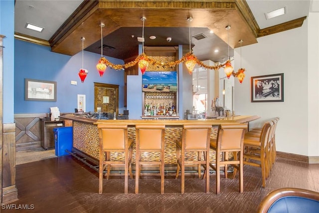 bar featuring beamed ceiling, decorative light fixtures, and crown molding