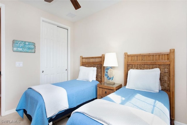 carpeted bedroom with ceiling fan and a closet