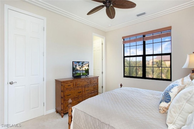 bedroom with light carpet, ceiling fan, and crown molding