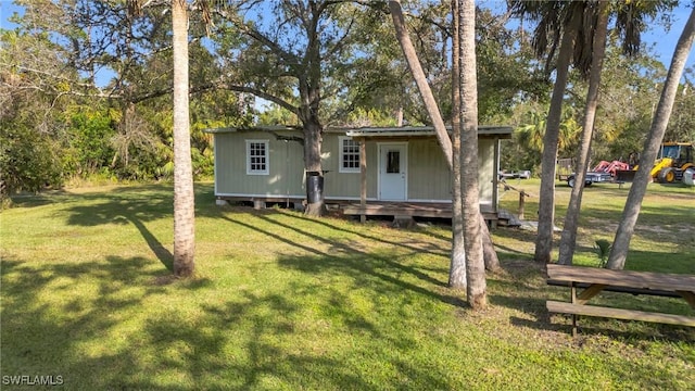 back of property with a lawn