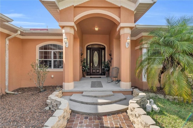 view of exterior entry with covered porch