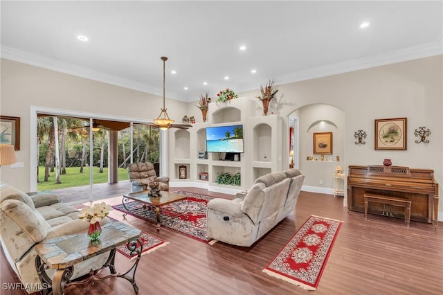 living room with wood-type flooring and ornamental molding