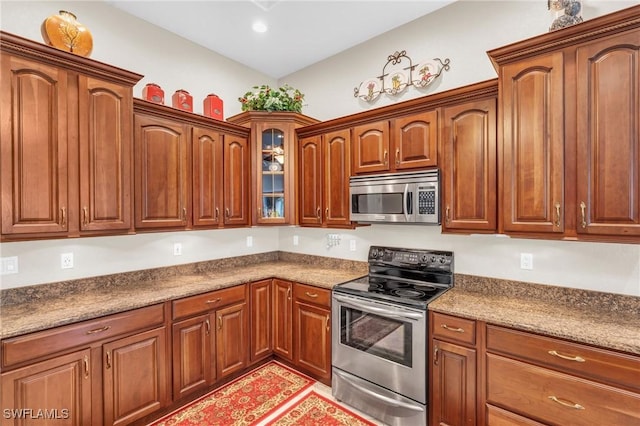 kitchen featuring stone counters and appliances with stainless steel finishes