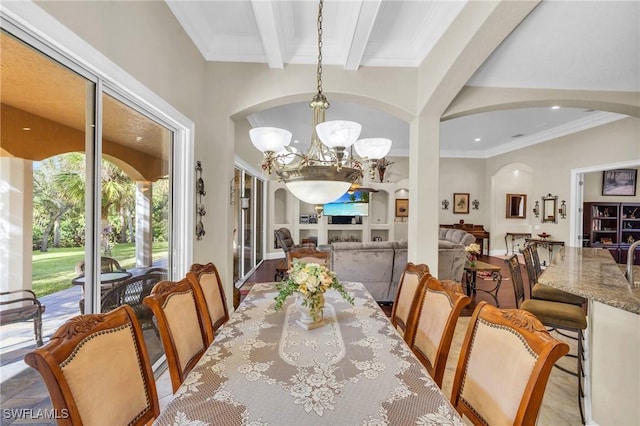 dining space featuring beam ceiling, crown molding, and a notable chandelier