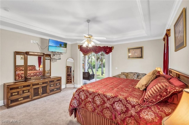 carpeted bedroom with a raised ceiling, access to exterior, ceiling fan, and crown molding